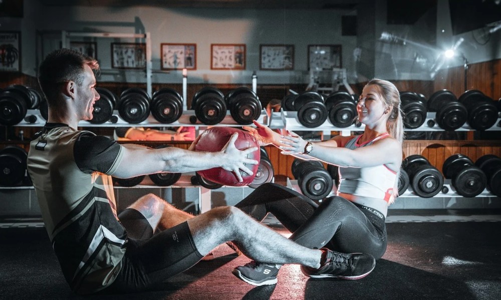 Couple doing medicine ball workout together.