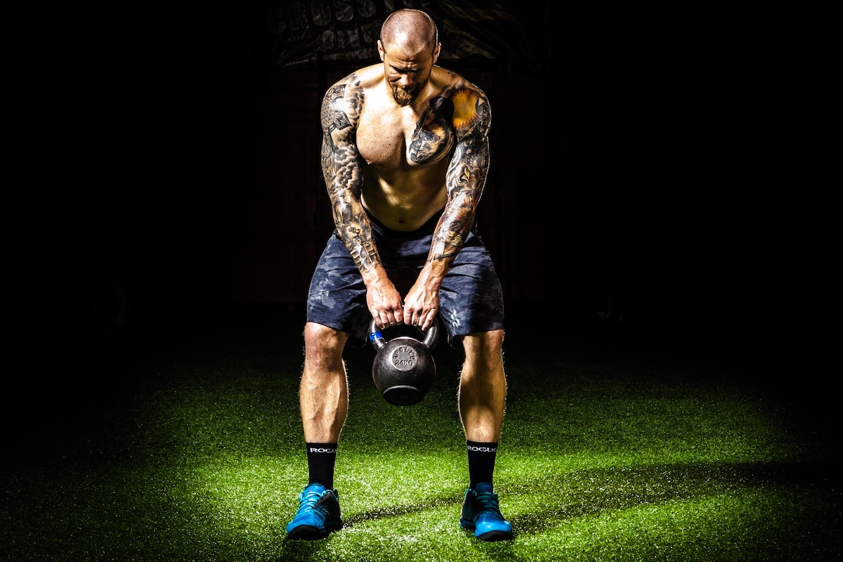 man doing kettlebell swings.