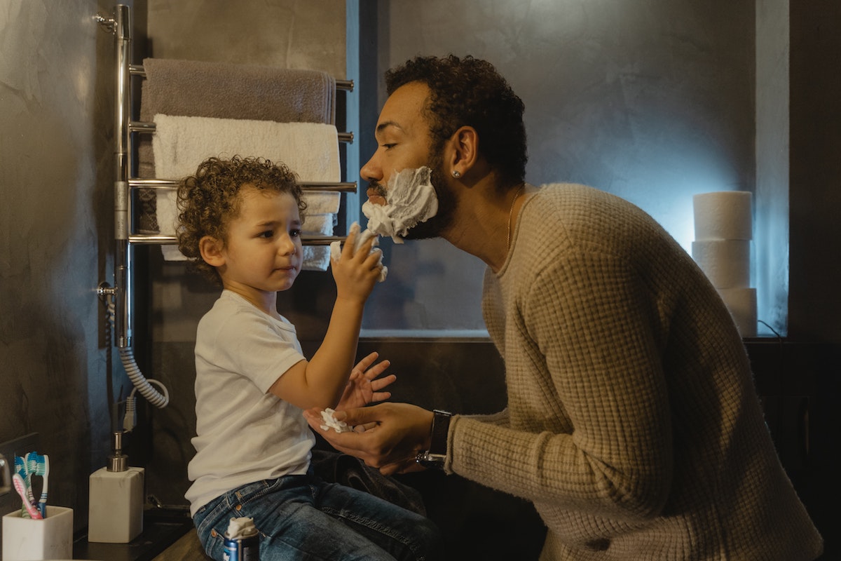 baby helping man shave.