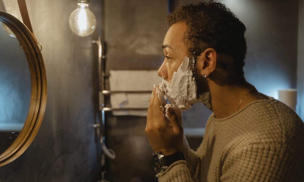 Man shaving in the mirror