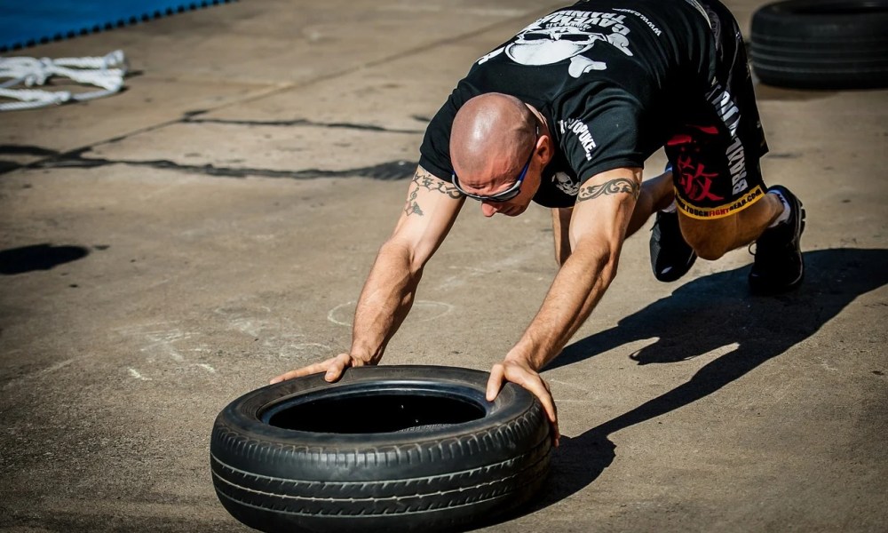 Man using tire crossfit workout