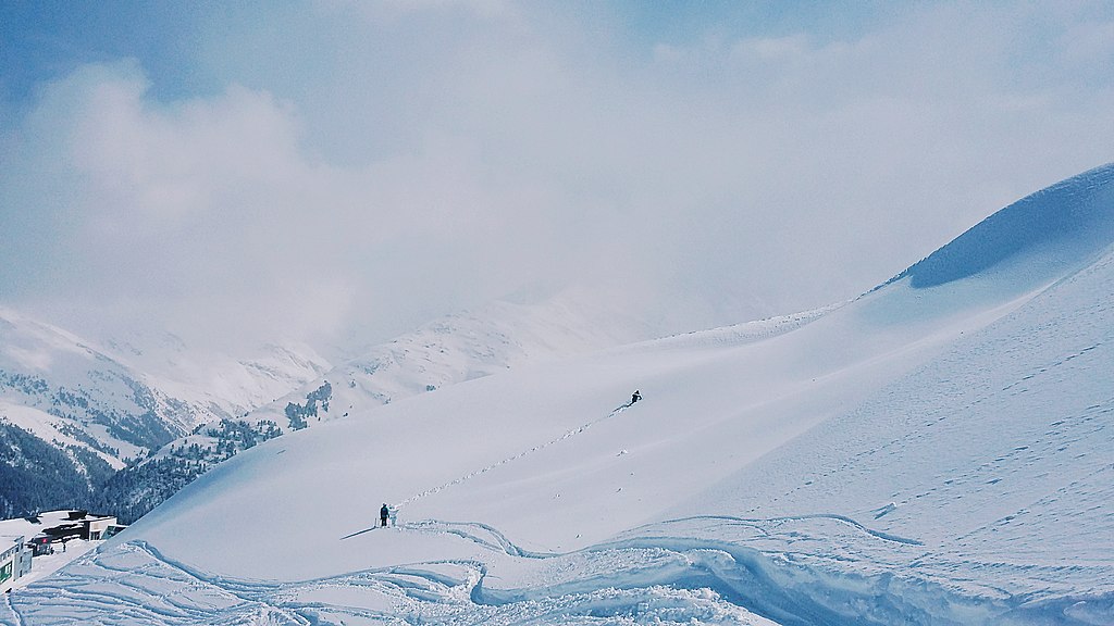 Skiers hiking up Arlberg Ski Area, Austria.