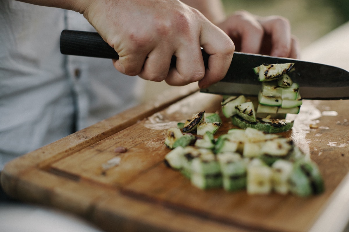 Slicing zucchini with a knife.