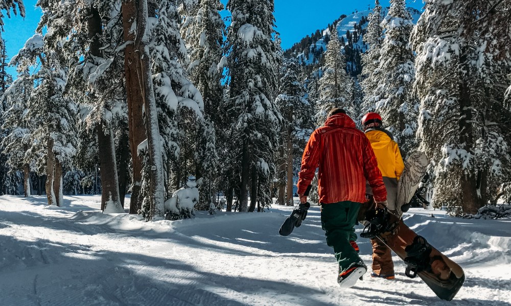 Snowboarders walking