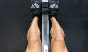 A man's strong legs from rowing.