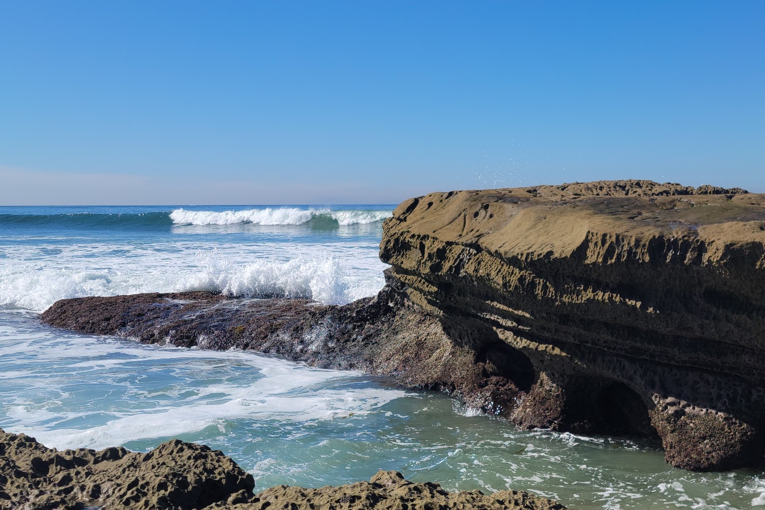 The waves approach the shoreline at the beach at Santa Cruz Cliffs in San Diego, California.