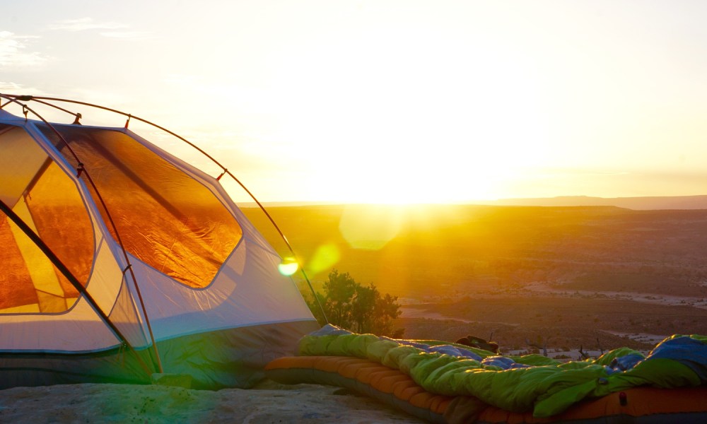 A camping sleeping pad sitting outside at sunrise.