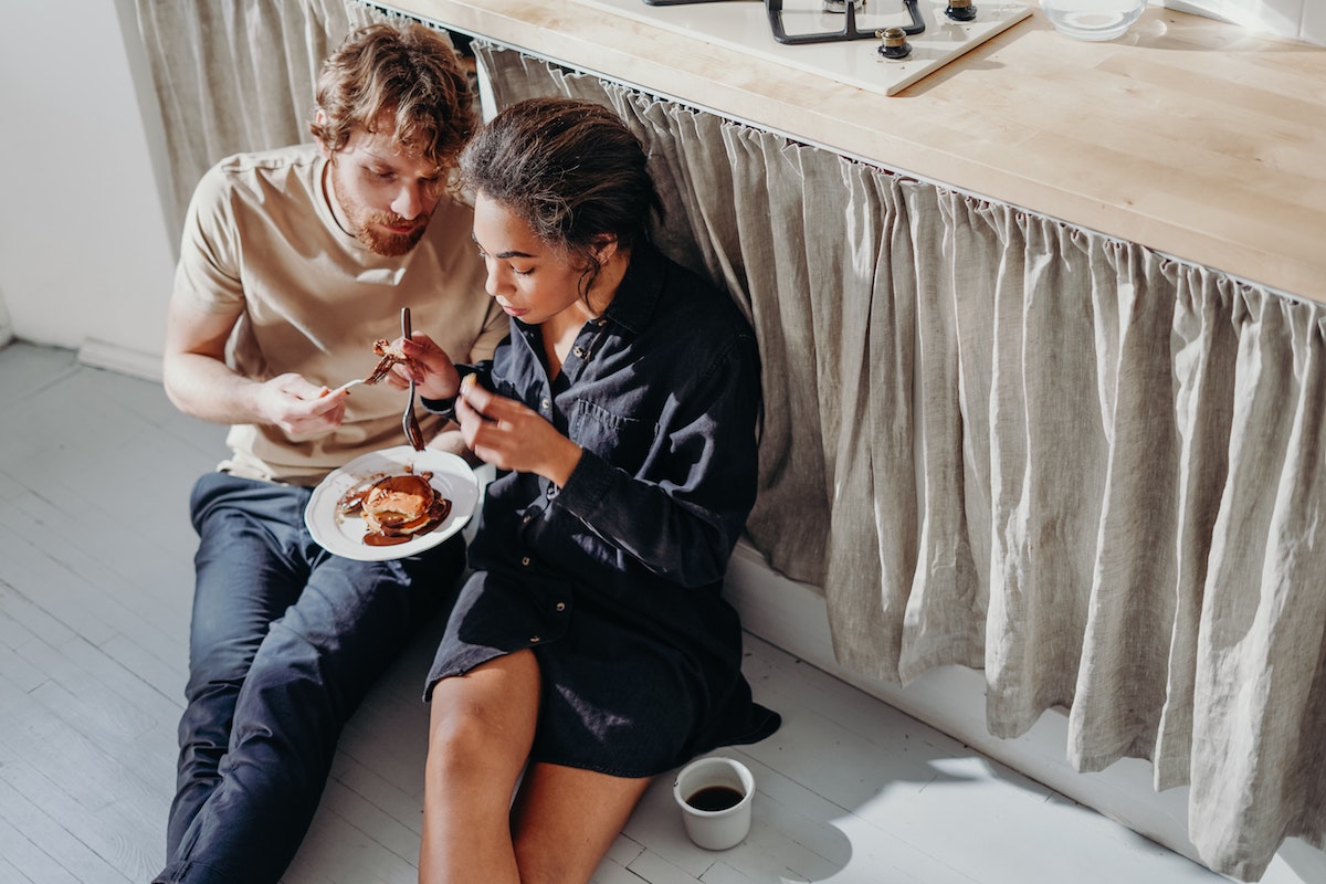 Couple sharing breakfast pancakes.