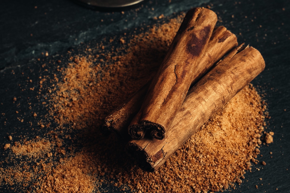 Thick cinnamon sticks on top of ground cinnamon.