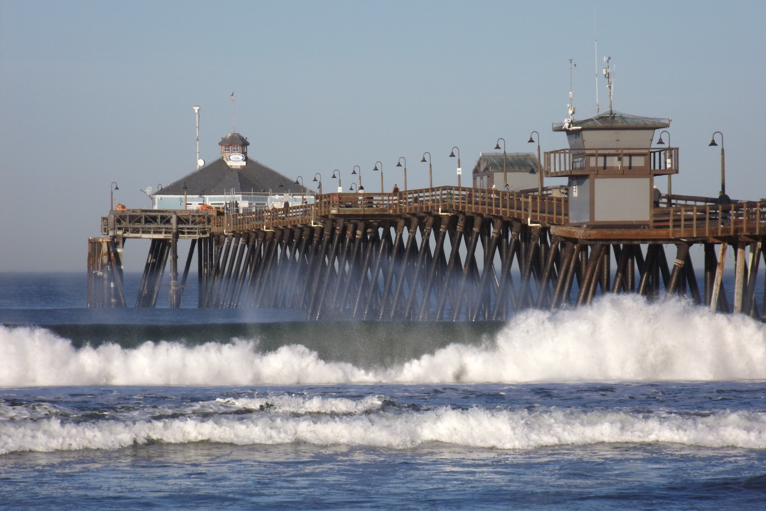 The waves crash onto the shore near the Imperial Beach Pier.