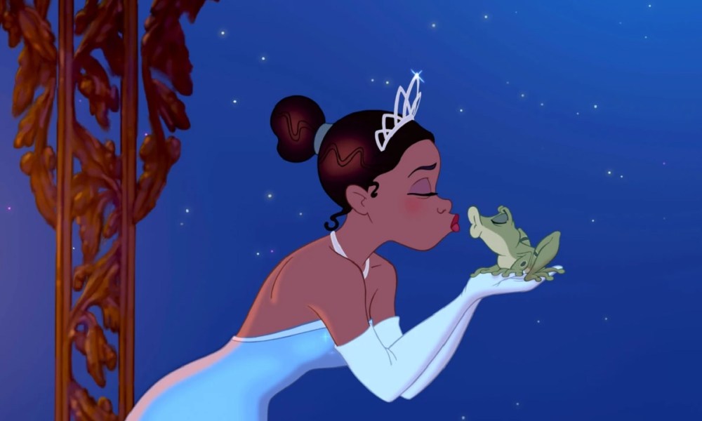 Tiana tries to kiss a frog in The Princess and the Frog.