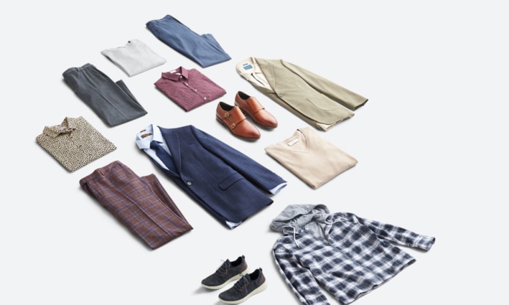 A variety of men's fashion essentials on the floor.