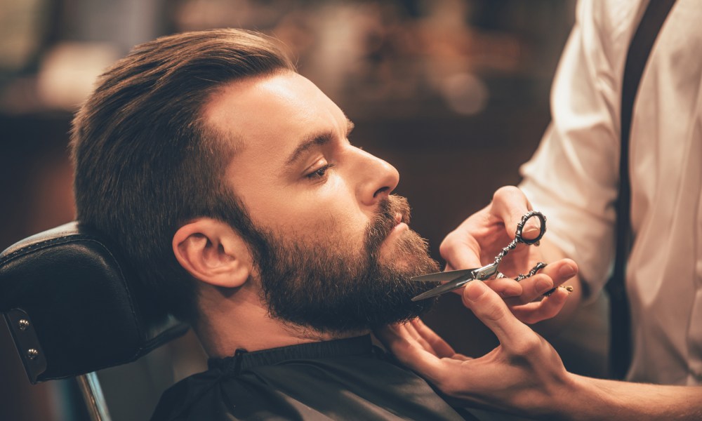 Man having his beard trimmed