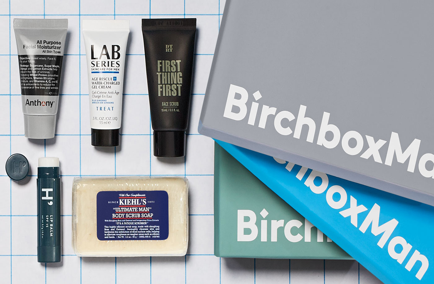 Three Birchbox boxes with skincare and grooming products.