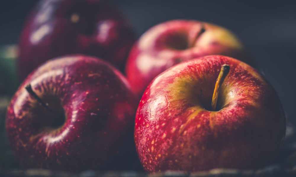 Red apples laying on a surface