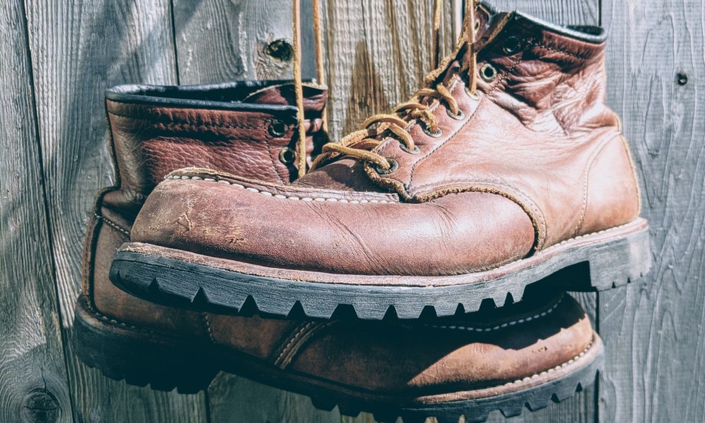 Worn in Redwing Moc Toe Boots hanging by their laces.