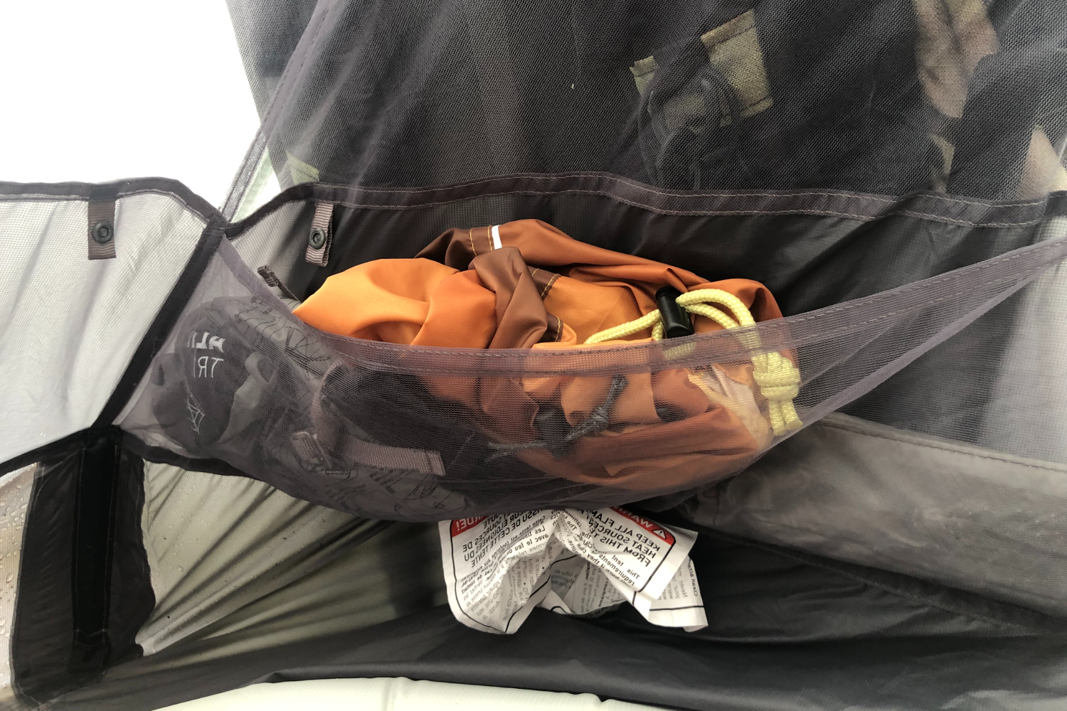 Interior storage pocket on a one-person tent for backpacking.