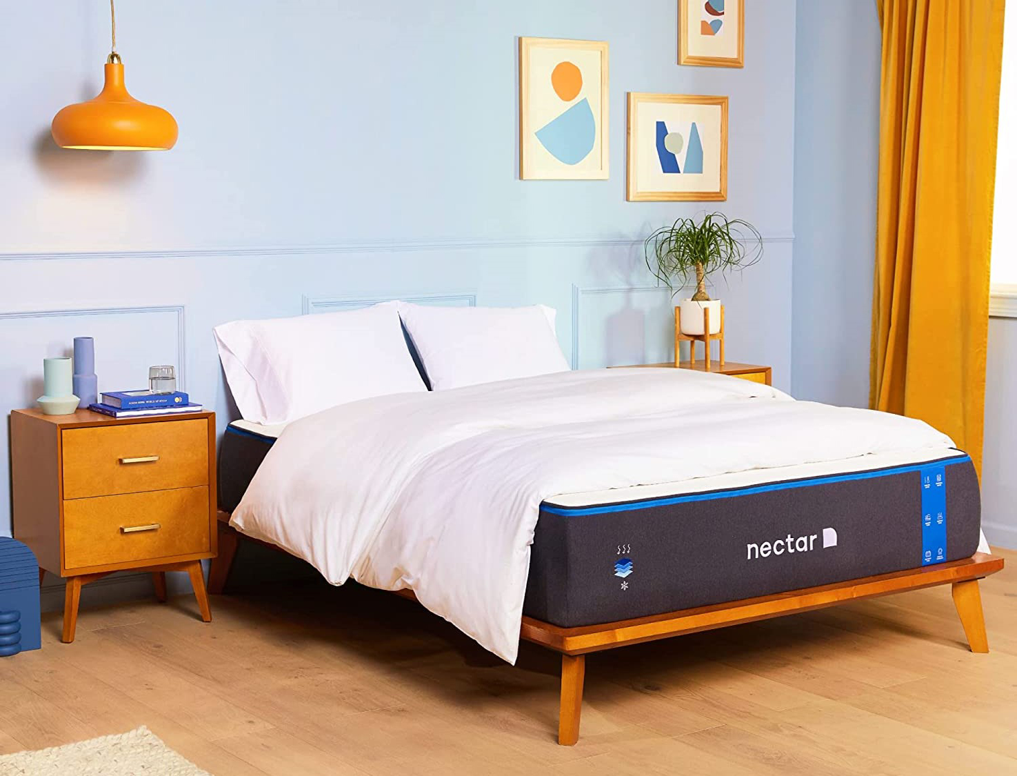 A Nectar mattress on a bed in a brightly lit bedroom.