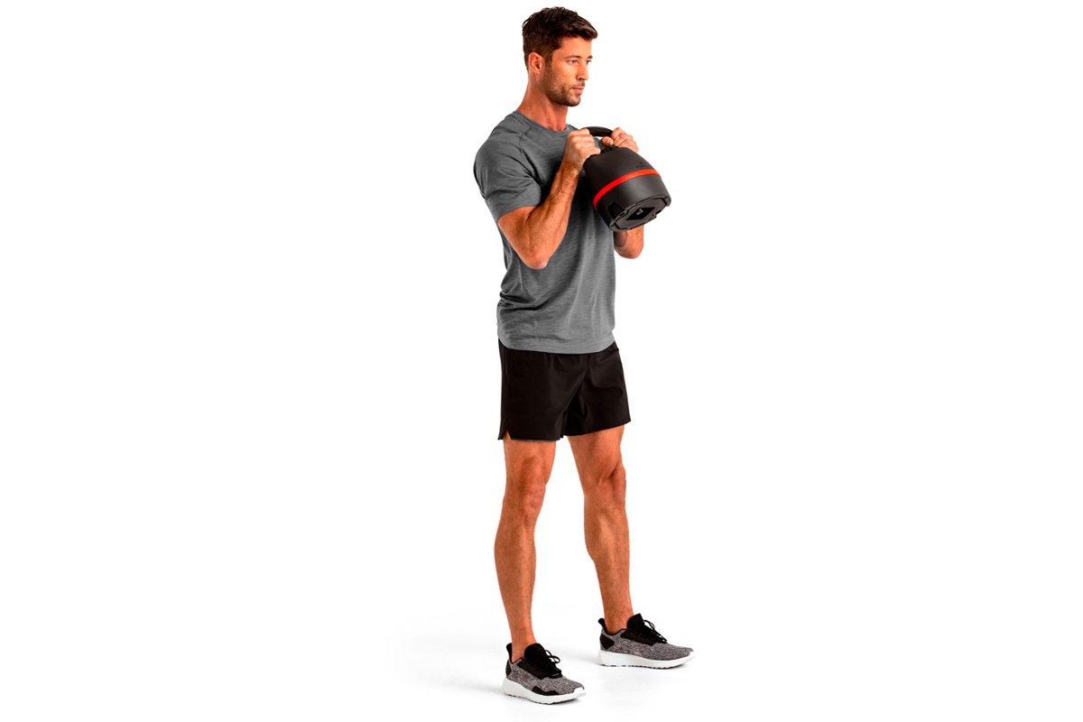 A man does kettlebell exercises.