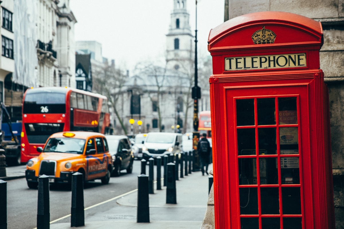 A telephone booth and cars on the streets of London.