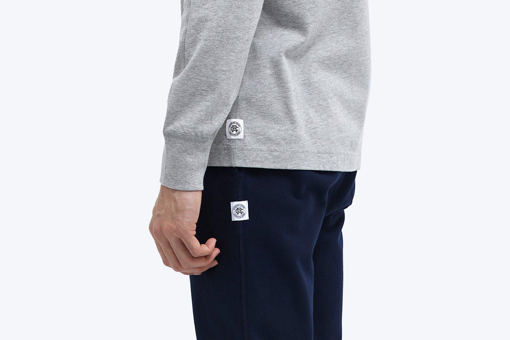 Man in Reigning Champ sweatshirt and sweatpants.