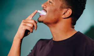 Man using snow wireless teeth whitening kit