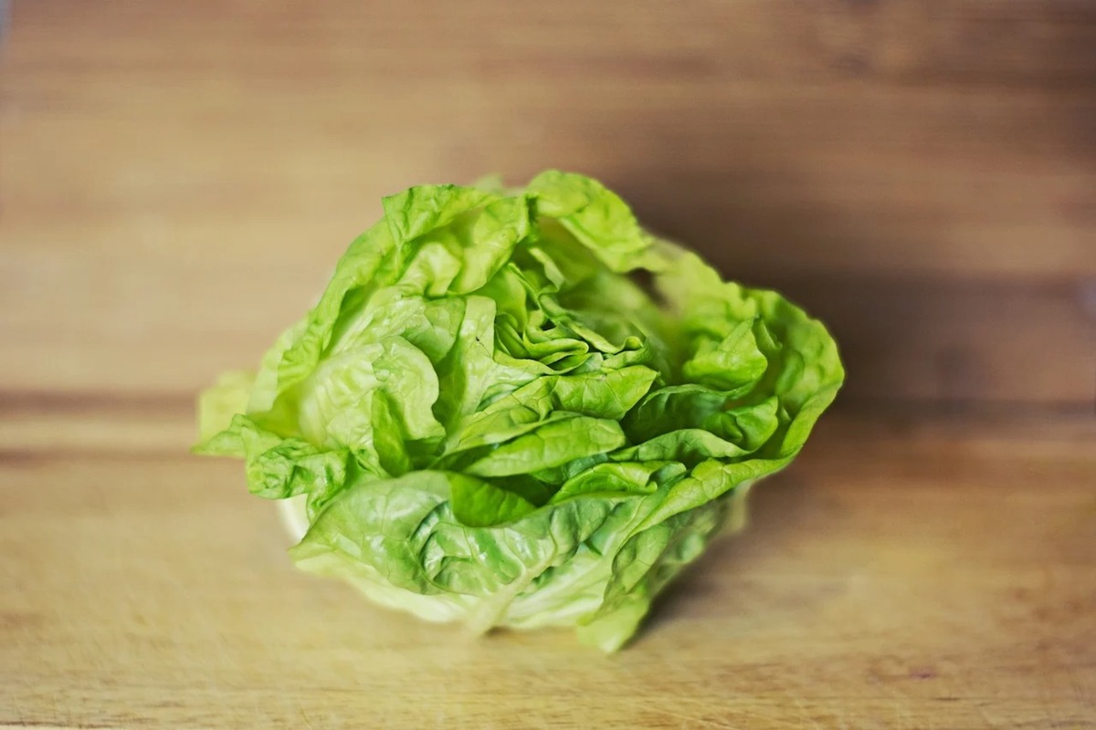 Butter lettuce on a board.