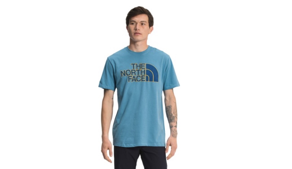 This is a model wearing a light blue north face tee.