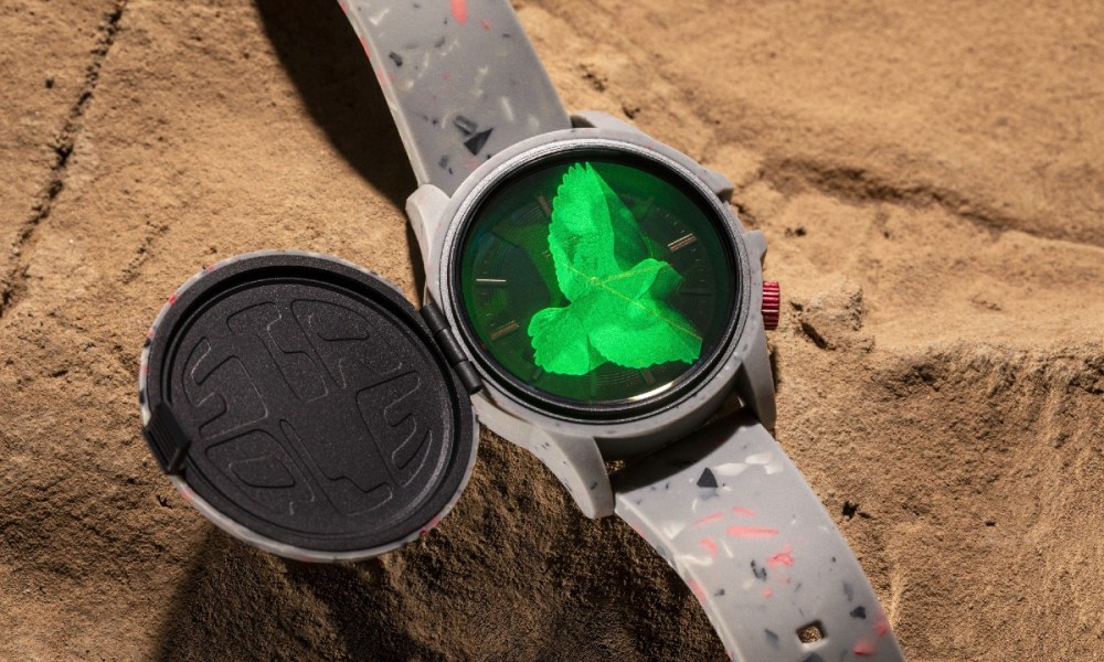 Staple x Fossil sundial watch with green pigeon hologram.