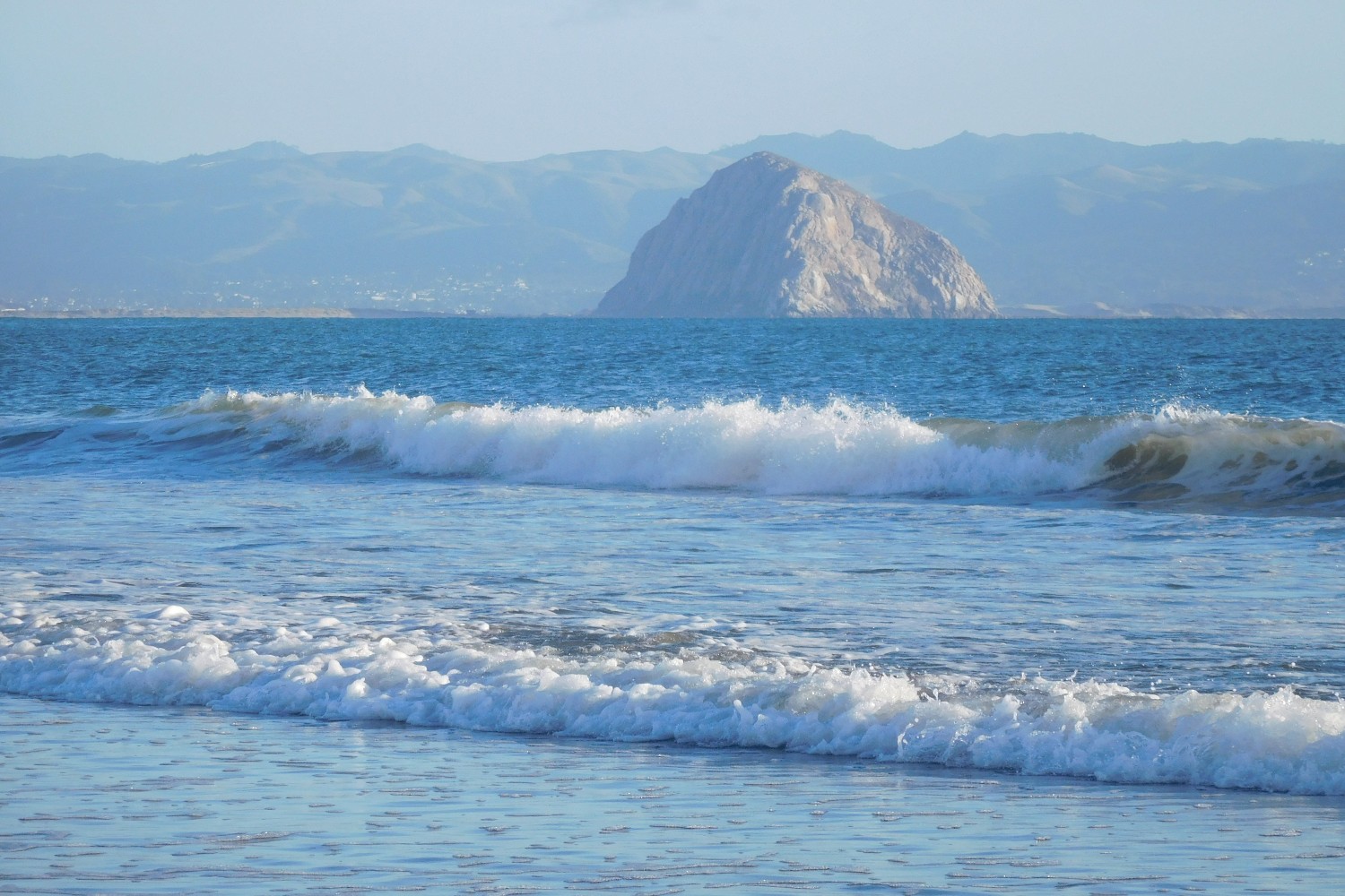 A view of Morro Rock and Morro Bay from the beach at Cayucos, California.