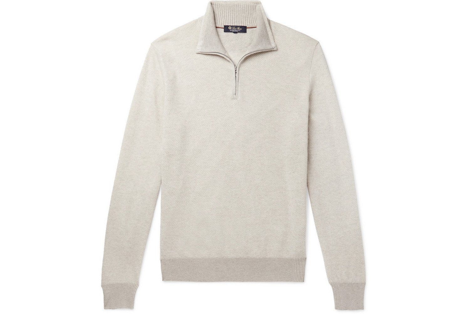 A cream colored half zip sweater.