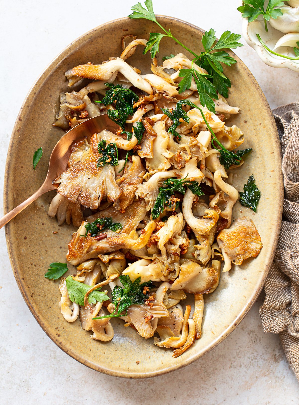 A plate of food with oyster mushrooms cooked in it.