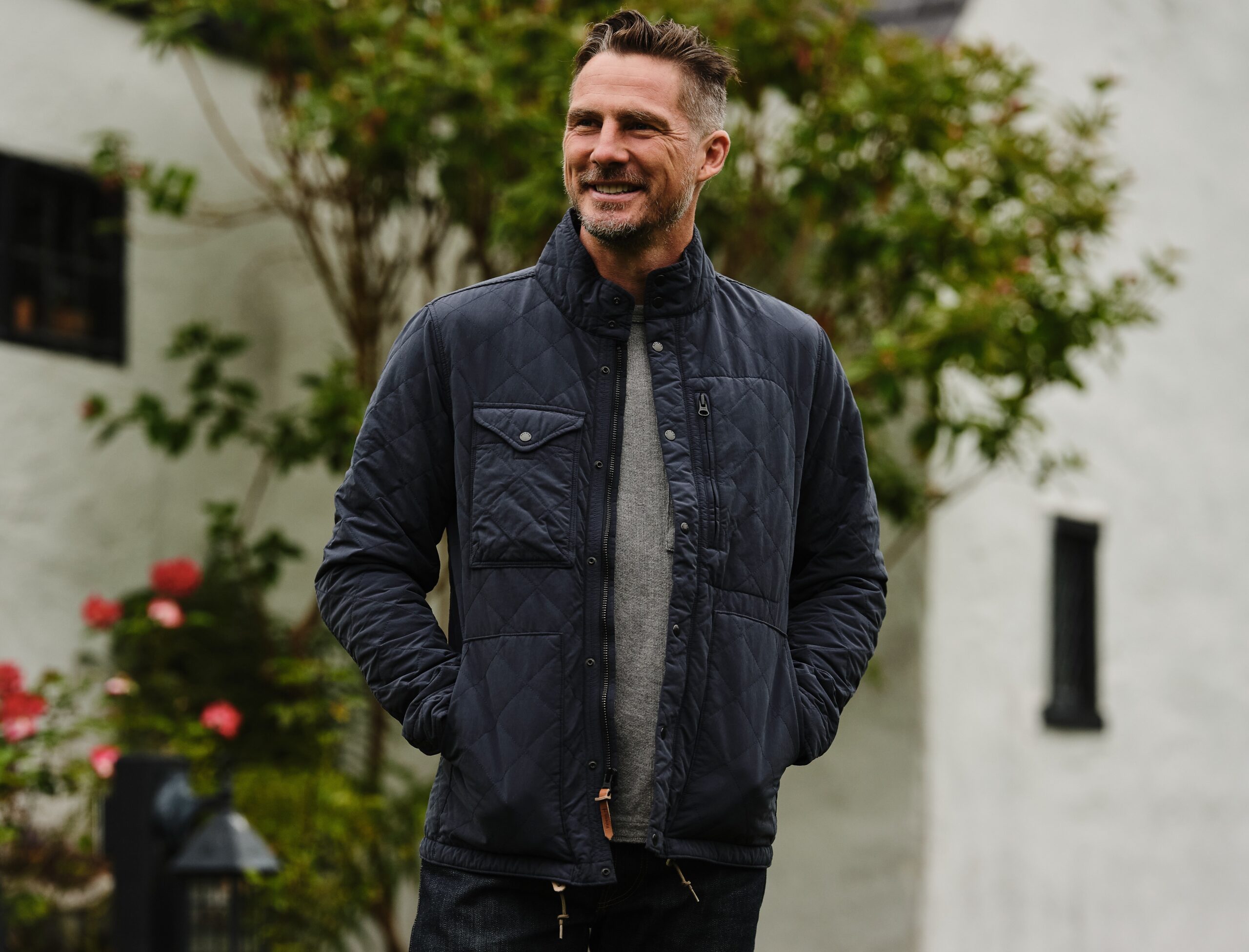 Man in a navy quilted jacket.