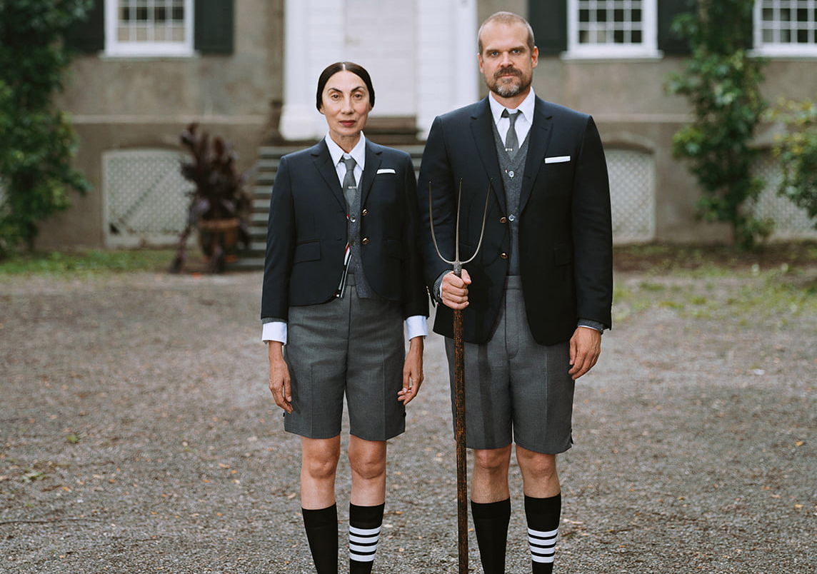 A man and woman wearing suits with shorts.