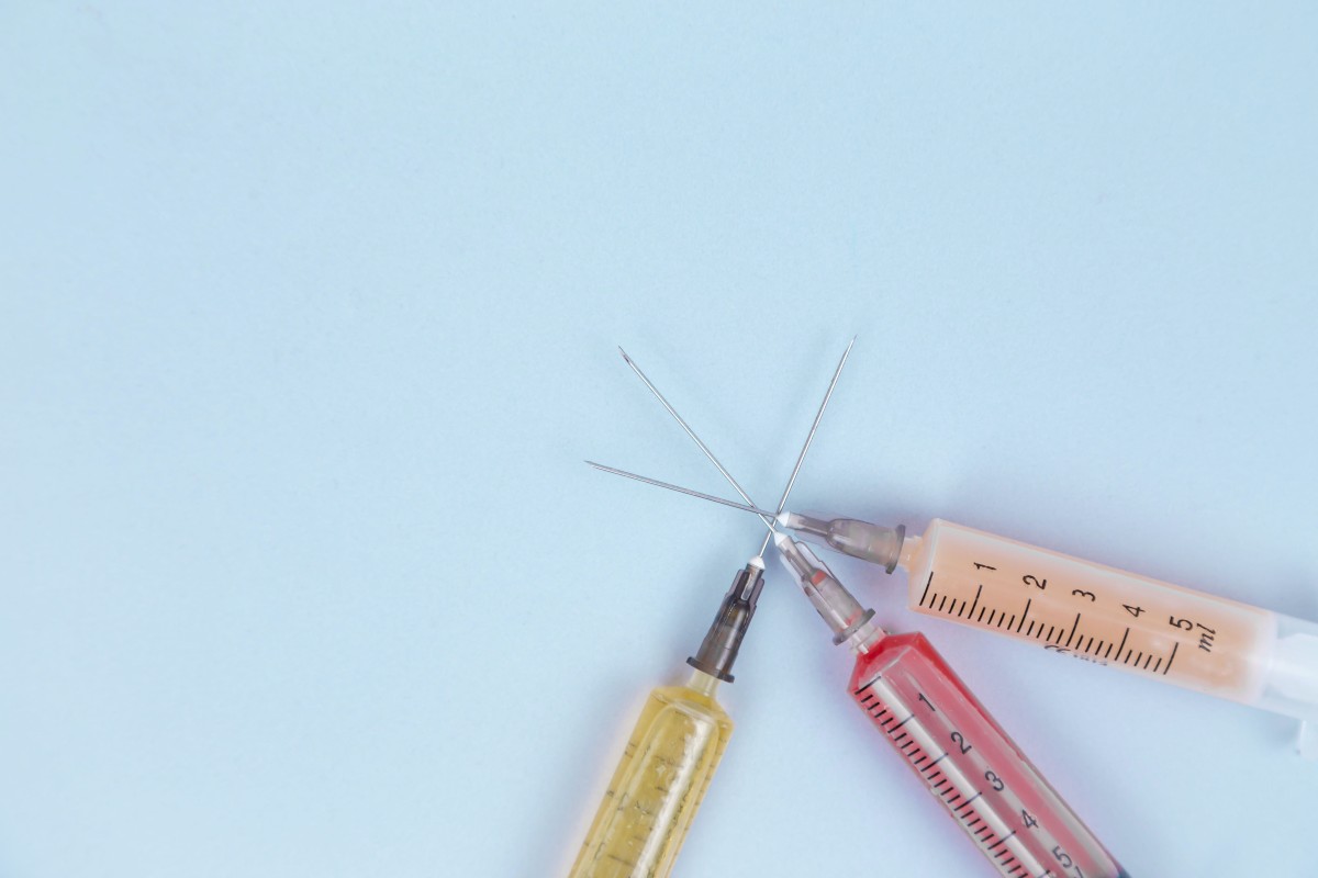 botox needles on blue background