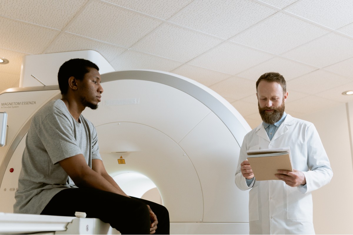 a male doctor talking to a male patient