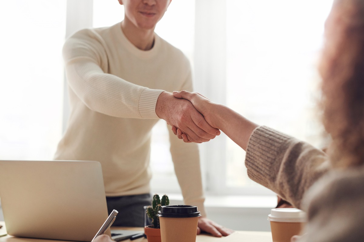 a male employee shaking hands with a female boss