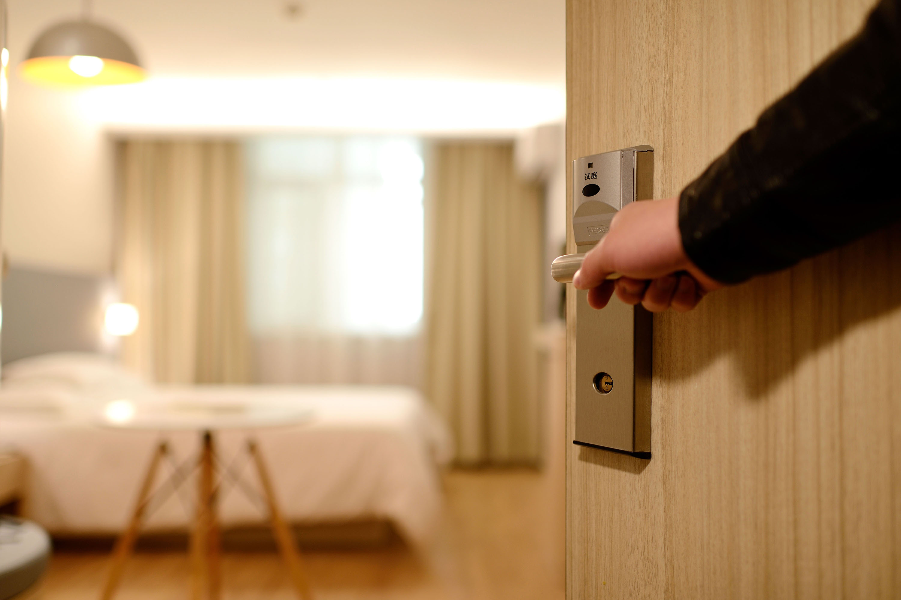 Person opening the door to a hotel room