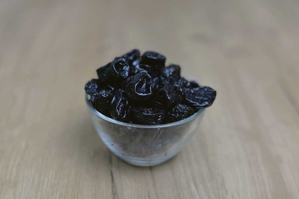 Dried prunes in a bowl.