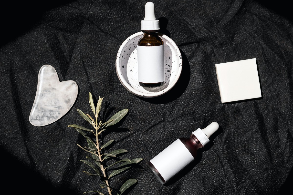 a flat lay of skincare products on black background