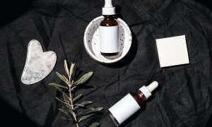 a flat lay of skincare products on black background