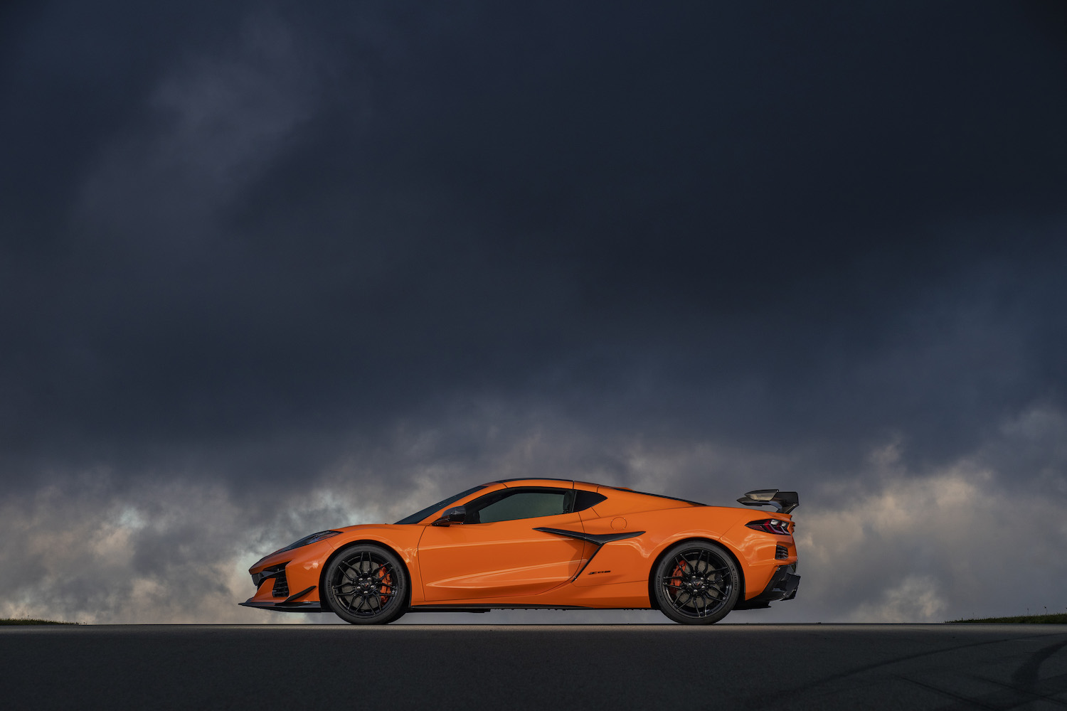 2023 Chevrolet Corvette Z06 side profile parked in front of dark, stormy clouds.