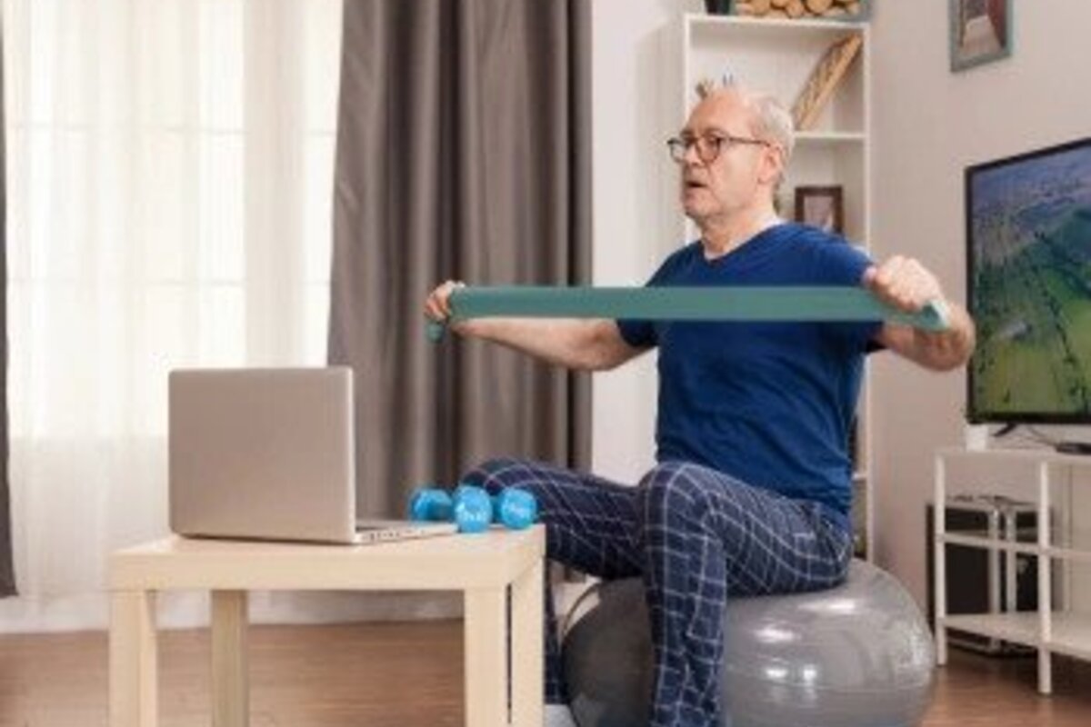 Senior man using resistance band while exercising.