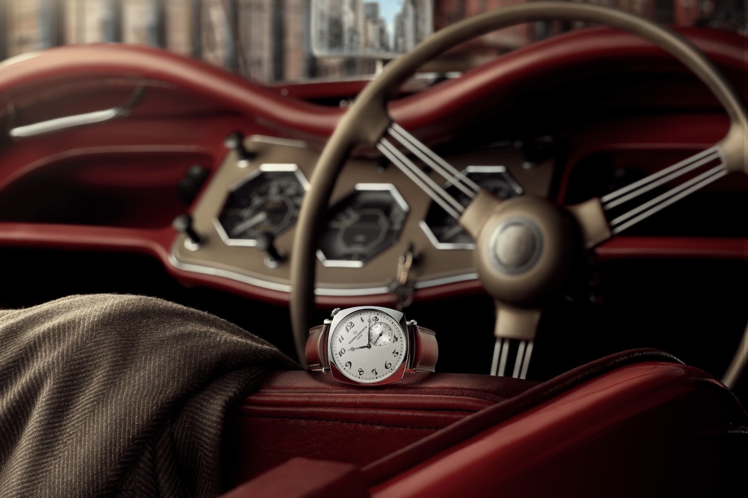 Vacheron Constantin Historiques American 1921 sitting on the seat of a classic car that's parked in a garage.