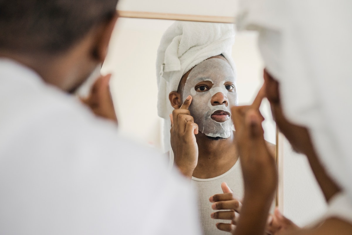 Man with mask looking into the mirror