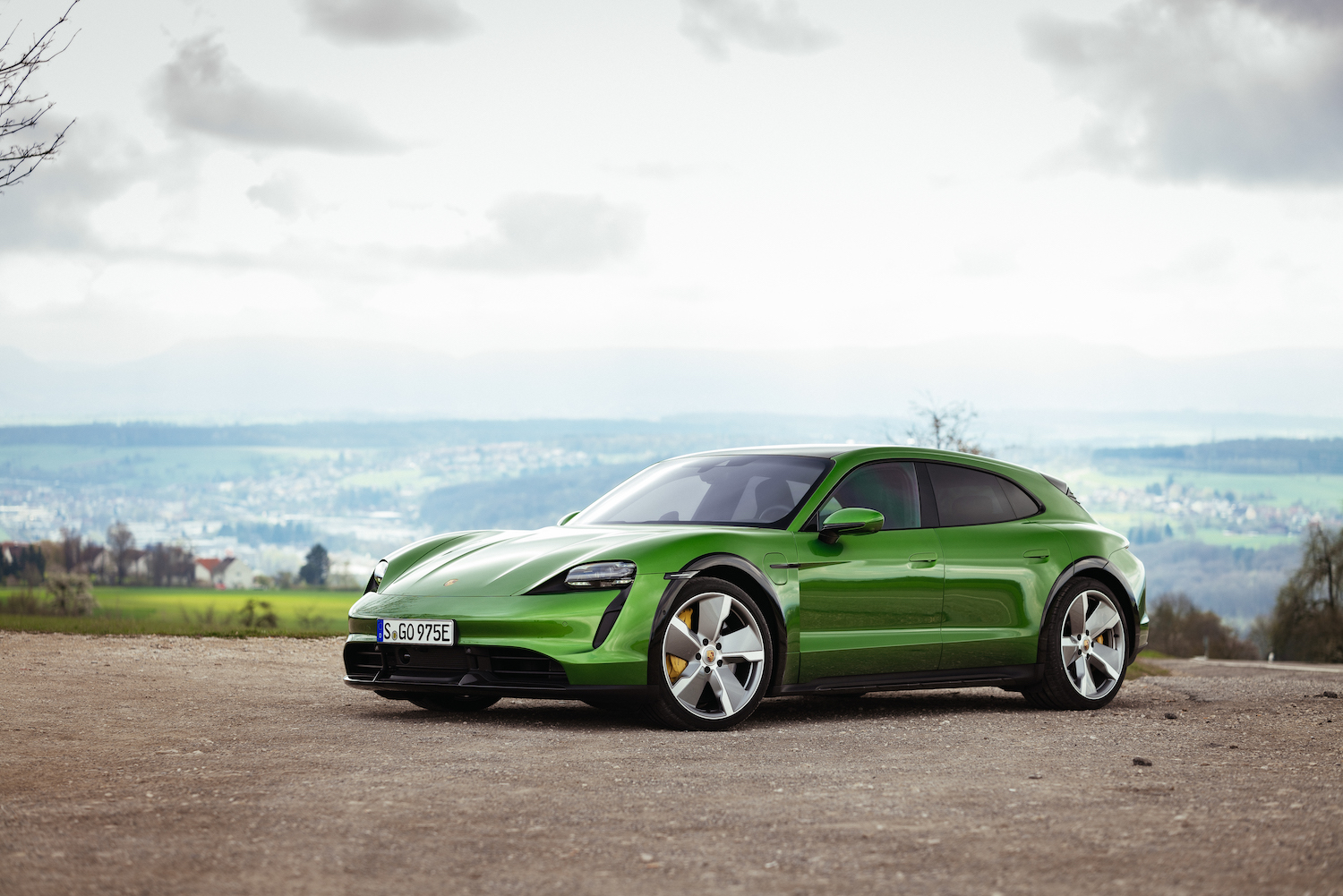 2022 Porsche Taycan Turbo S Cross Turismo front end angle from driver's side parked in front of an ocean.