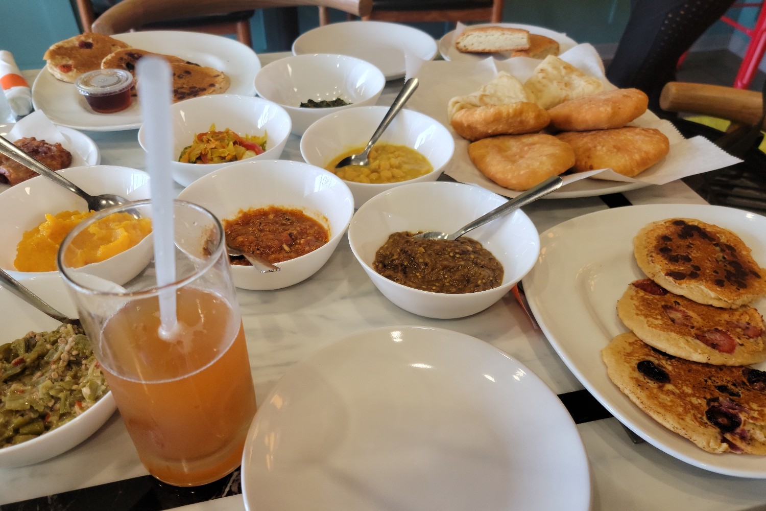 A table full of dishes and food at Soca Vegan Kitchen in Augusta, Georgia.