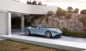 2024 Ferrari Roma front end angle from driver's side parked in front of house with cliff in the back.