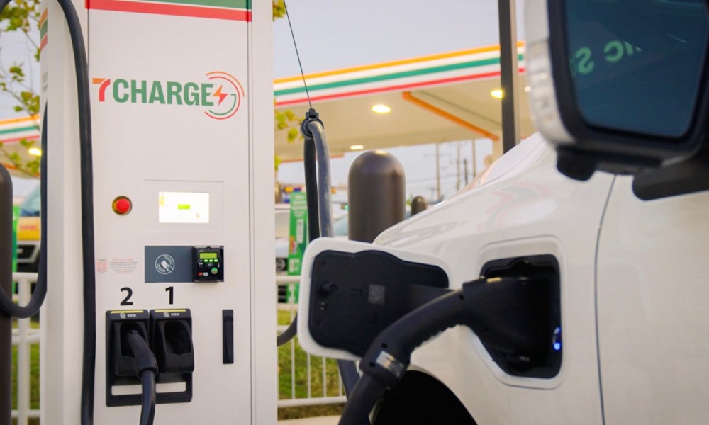 7Charge electric vehicle charging station by 7-Eleven with an EV charging at a convenience store