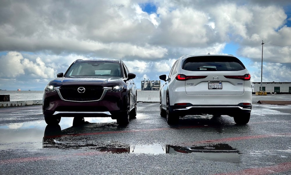 2024 Mazda CX-90 and PHEV front and rear end parked in front of dark clouds.